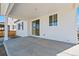 Covered patio with a sliding glass door and modern white siding at 9175 Uravan Ct, Commerce City, CO 80022
