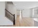View of the home's staircase with wood trim and neutral carpet and flooring at 9175 Uravan Ct, Commerce City, CO 80022
