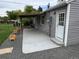 Covered back porch with a concrete floor, next to the home's back door at 1405 S Utica St, Denver, CO 80219