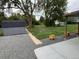 Large backyard with a shed, big trees, and planter boxes along the covered porch at 1405 S Utica St, Denver, CO 80219