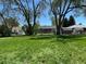 A large, grassy backyard with mature trees that provide ample shade at 1405 S Utica St, Denver, CO 80219