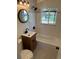 Bathroom featuring subway tile, black fixtures, and a garden view window at 1405 S Utica St, Denver, CO 80219