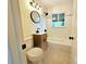 Cozy bathroom with updated vanity, a well-lit mirror, and subway tile at 1405 S Utica St, Denver, CO 80219