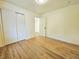 A clean bedroom features new floors, closet, and doorway to the bathroom at 1405 S Utica St, Denver, CO 80219