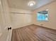 A bright bedroom with neutral walls, closet shelving, and a large window that brings in ample light at 1405 S Utica St, Denver, CO 80219