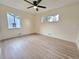 The bedroom is filled with natural light coming from two windows, light paint and wood floors at 1405 S Utica St, Denver, CO 80219
