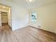 Well-lit bedroom featuring new floors, and a window with views of the outdoor greenery at 1405 S Utica St, Denver, CO 80219