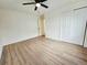 Spacious bedroom with hardwood floors, modern ceiling fan, and closet at 1405 S Utica St, Denver, CO 80219