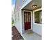 Inviting front entryway with a red door and stylish welcome mat at 1405 S Utica St, Denver, CO 80219