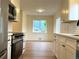 Well-equipped kitchen featuring stainless steel appliances and white cabinetry at 1405 S Utica St, Denver, CO 80219