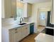 Modern kitchen featuring white cabinetry, a stylish faucet, and stainless steel appliances at 1405 S Utica St, Denver, CO 80219