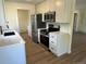 Updated kitchen with stainless steel appliances, sleek countertops, and ample storage space at 1405 S Utica St, Denver, CO 80219