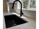 Modern sink featuring stainless steel appliances, sleek countertops, and ample storage space at 1405 S Utica St, Denver, CO 80219