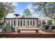 Backyard featuring a wooden deck, an outdoor dining area, and a pergola perfect for entertaining at 4011 S Ivy Ln, Cherry Hills Village, CO 80111