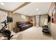 Finished basement with cozy seating, plush carpet, and workout space, ideal for relaxation and fitness at 4011 S Ivy Ln, Cherry Hills Village, CO 80111