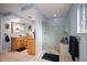 Bathroom with double sink vanities, walk-in shower, and neutral tile flooring at 4011 S Ivy Ln, Cherry Hills Village, CO 80111