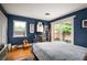 Comfortable bedroom featuring hardwood floors, natural light, and a sliding glass door to an outdoor patio at 4011 S Ivy Ln, Cherry Hills Village, CO 80111