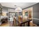 Formal dining room with elegant lighting, hardwood floors, and access to living areas at 4011 S Ivy Ln, Cherry Hills Village, CO 80111