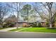 Charming home with lush landscaping, mature trees, and brick exterior at 4011 S Ivy Ln, Cherry Hills Village, CO 80111