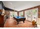 Spacious game room with brick walls, multiple windows, and a pool table at 4011 S Ivy Ln, Cherry Hills Village, CO 80111