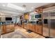 Modern kitchen with stainless steel appliances, granite countertops, and an open floor plan at 4011 S Ivy Ln, Cherry Hills Village, CO 80111
