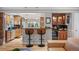 Charming kitchen featuring a breakfast bar, wet bar, and cabinetry, perfect for entertaining and relaxation at 4011 S Ivy Ln, Cherry Hills Village, CO 80111