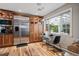 Bright kitchen featuring stainless steel appliances, wood cabinets, and adjacent breakfast nook with backyard views at 4011 S Ivy Ln, Cherry Hills Village, CO 80111