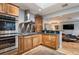 Updated kitchen with stainless steel appliances, wood cabinetry, and granite countertops at 4011 S Ivy Ln, Cherry Hills Village, CO 80111