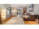 Bright living room with hardwood floors, modern furnishings, and access to the backyard at 4011 S Ivy Ln, Cherry Hills Village, CO 80111