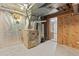 Unfinished basement featuring insulation and a water heater at 6222 S Ames Ct, Littleton, CO 80123