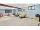 Cozy basement area with comfortable seating, soft carpeting, and stylish decor at 6222 S Ames Ct, Littleton, CO 80123