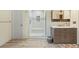 Bathroom with a tiled shower, modern vanity, and stylish fixtures at 6222 S Ames Ct, Littleton, CO 80123