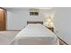 This carpeted bedroom features a lamp, and a small window at 6222 S Ames Ct, Littleton, CO 80123