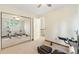 This carpeted bedroom features a ceiling fan and a mirrored sliding-door closet at 6222 S Ames Ct, Littleton, CO 80123