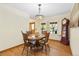 Inviting dining room with hardwood floors, elegant lighting, and a classic grandfather clock at 6222 S Ames Ct, Littleton, CO 80123