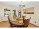 Charming dining room with wood floors and a decorative lighting fixture, great for Gathering meals at 6222 S Ames Ct, Littleton, CO 80123