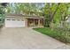 Charming two-story home with a brick facade, attached garage, and a well-maintained front yard at 6222 S Ames Ct, Littleton, CO 80123