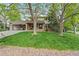 Charming two-story home with mature trees, brick accents, and a spacious driveway at 6222 S Ames Ct, Littleton, CO 80123