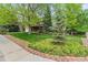 Well-manicured lawn and landscaping enhance the curb appeal of this inviting home at 6222 S Ames Ct, Littleton, CO 80123