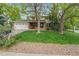 Charming two-story home with brick accents, mature trees, lush lawn, and a two car garage at 6222 S Ames Ct, Littleton, CO 80123