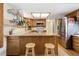 Modern kitchen with stainless steel appliances, granite countertops, and a stylish island with bar seating at 6222 S Ames Ct, Littleton, CO 80123