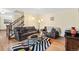 Cozy living room with hardwood floors, comfortable leather sofas, and stylish decor, perfect for relaxation at 6222 S Ames Ct, Littleton, CO 80123