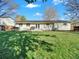 Expansive backyard featuring a lush green lawn, patio, and solar panels for energy efficiency and outdoor living at 10878 Grange Creek Dr, Thornton, CO 80233