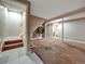 Unfinished basement area with a staircase, closet, and large open space with brown carpet flooring at 10878 Grange Creek Dr, Thornton, CO 80233