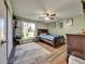 Bright bedroom with a ceiling fan, wood floors, and a large window providing lots of natural light at 10878 Grange Creek Dr, Thornton, CO 80233