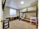 Bedroom with carpet flooring, bunk bed, desk, storage, and a window with a view at 10878 Grange Creek Dr, Thornton, CO 80233