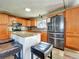 Bright kitchen featuring stainless steel appliances, granite countertops, a tiled backsplash, and island seating at 10878 Grange Creek Dr, Thornton, CO 80233