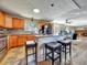 Bright kitchen with stainless appliances, granite countertops, island seating, and an open layout to the dining area at 10878 Grange Creek Dr, Thornton, CO 80233