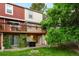 A backyard view showcasing a wooden deck, a lawn area, and some exterior storage at 9946 W Cornell Pl, Lakewood, CO 80227
