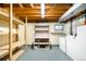 Basement storage area with shelving, laundry machines, and painted floor at 9946 W Cornell Pl, Lakewood, CO 80227